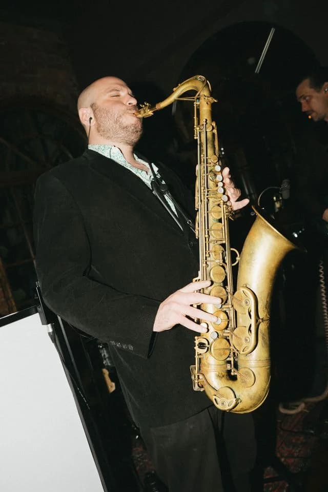 A saxophonist performing at an event