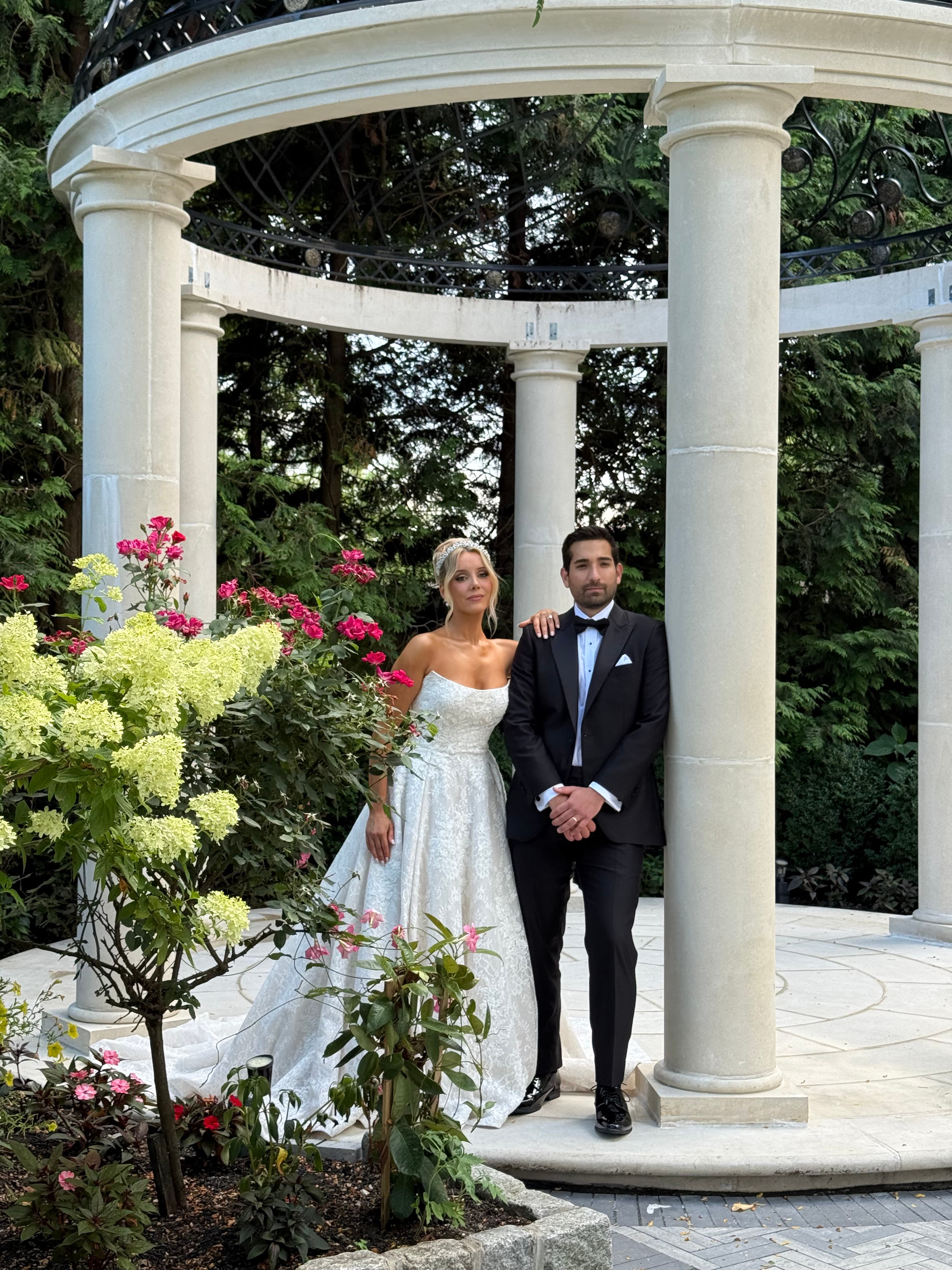 Courtney Lynn and her groom beneath a white stone gazebo at Florentine Gardens in River Vale, New Jersey